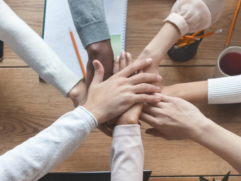 People putting hands together for united, cooperation and teamwork concept